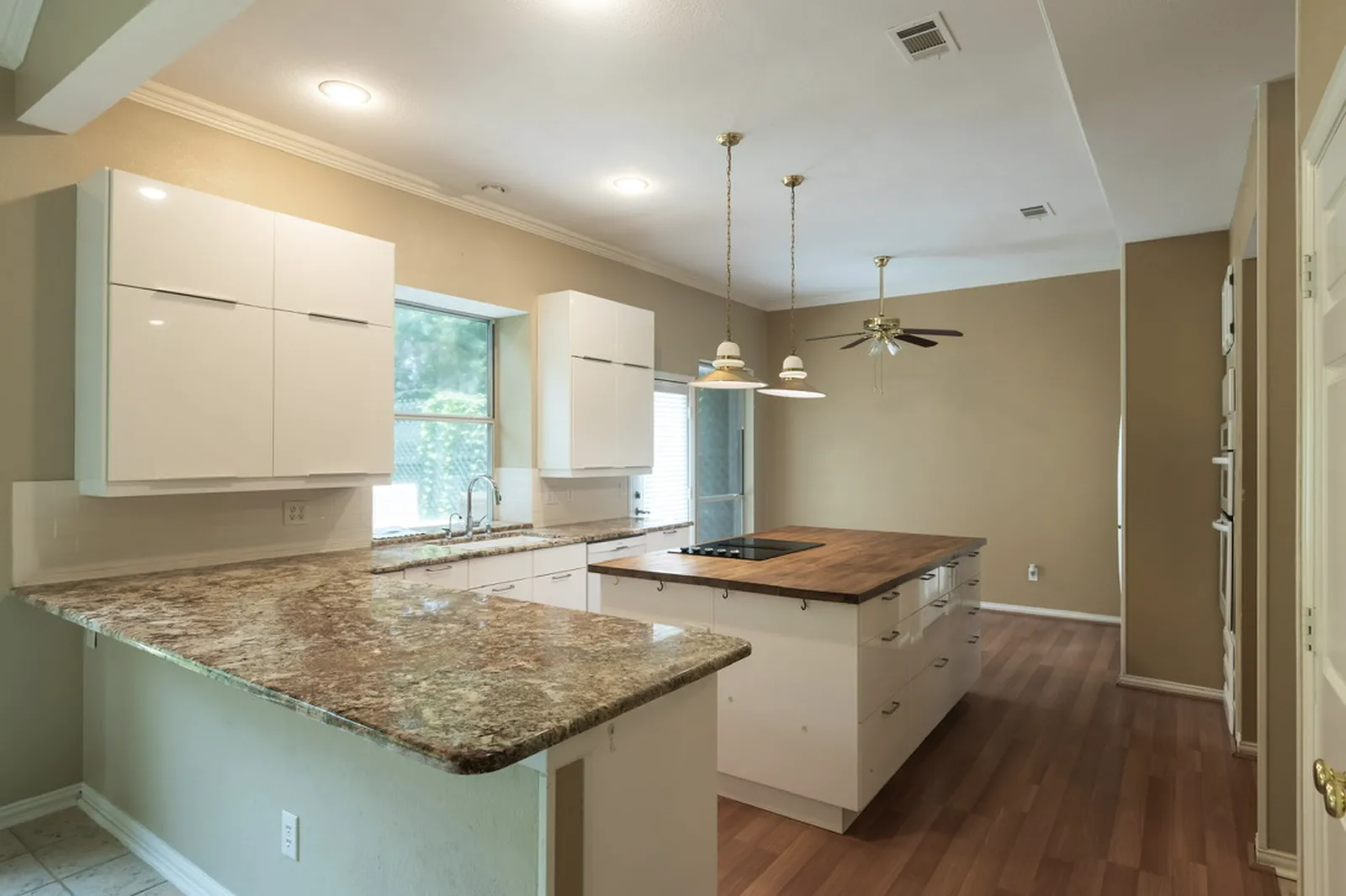 Azure Ln. kitchen in Addison before the renovation: dated granite counters and original layout