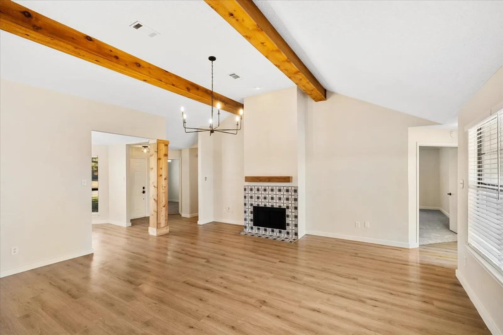 Haven Pl. living room in Allen before the renovation: brick fireplace and exposed beams