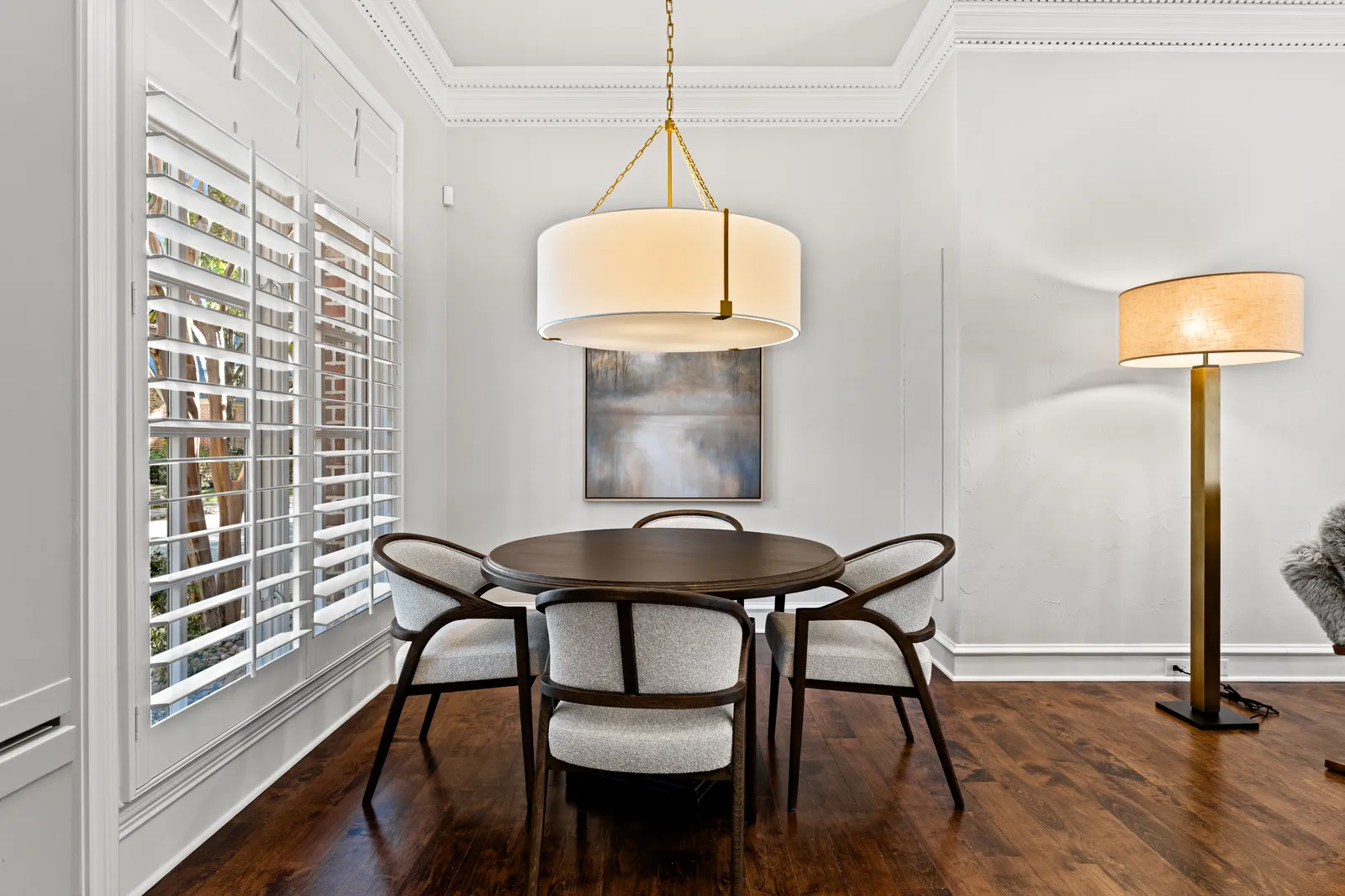 Breakfast nook at Prestwick Ln in Dallas, TX after fresh paint, a new pendant, and refinished hardwood floors by Renovation Sells Dallas