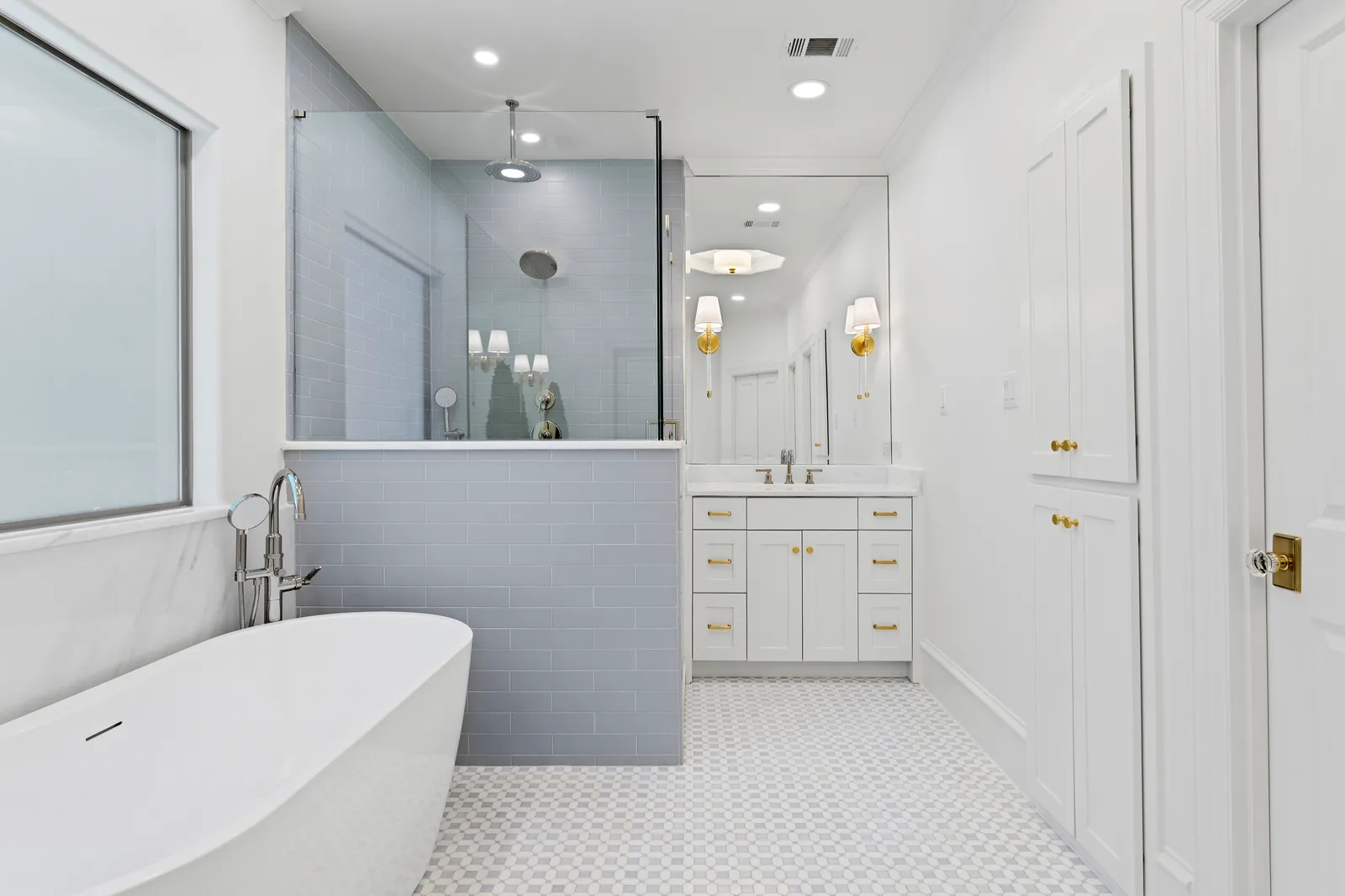 Freestanding tub beside the gray subway-tile shower at Revere Pl. in Lakewood