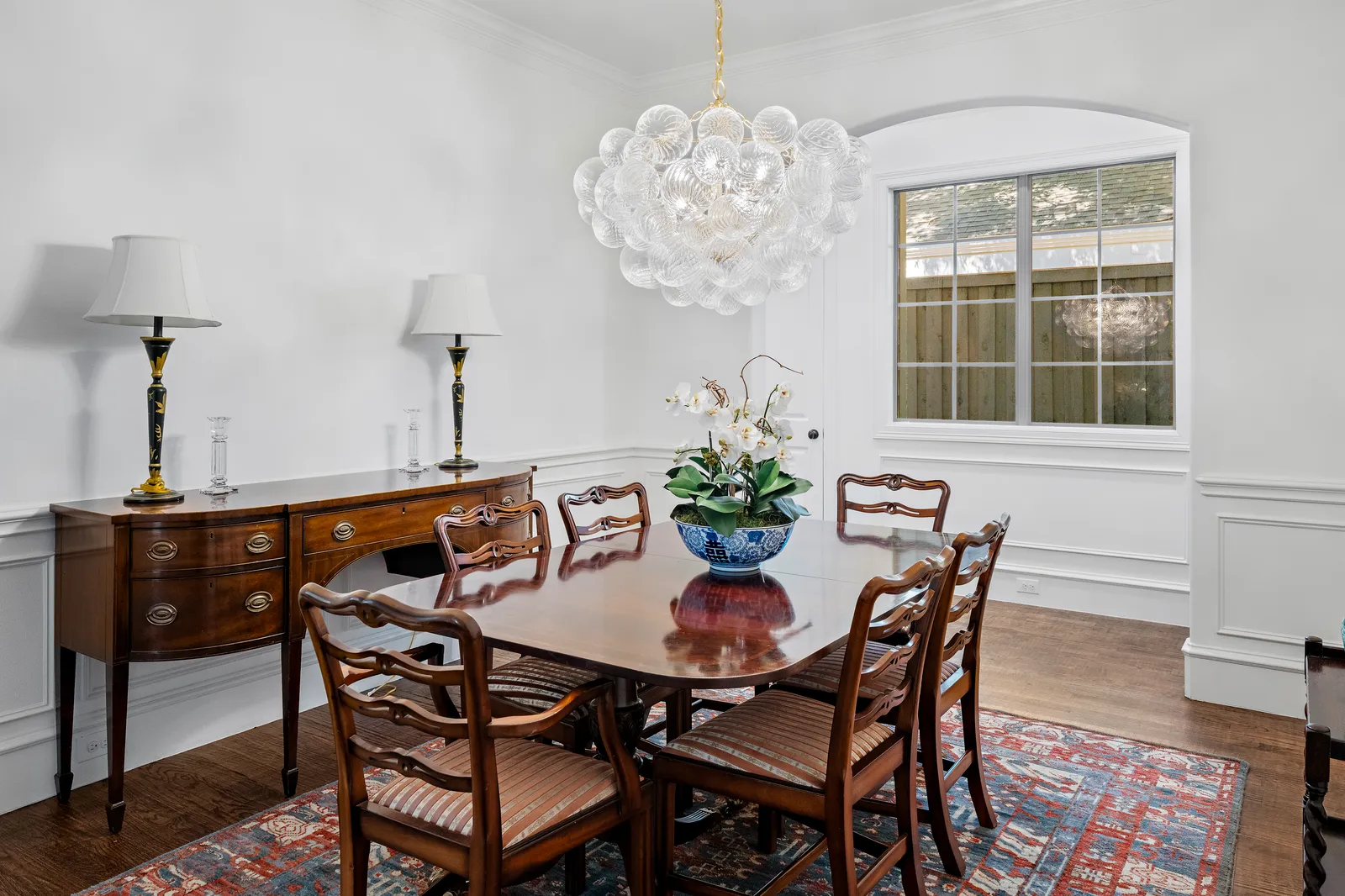 Dining room with bubble chandelier and antique table at Revere Pl. in Lakewood