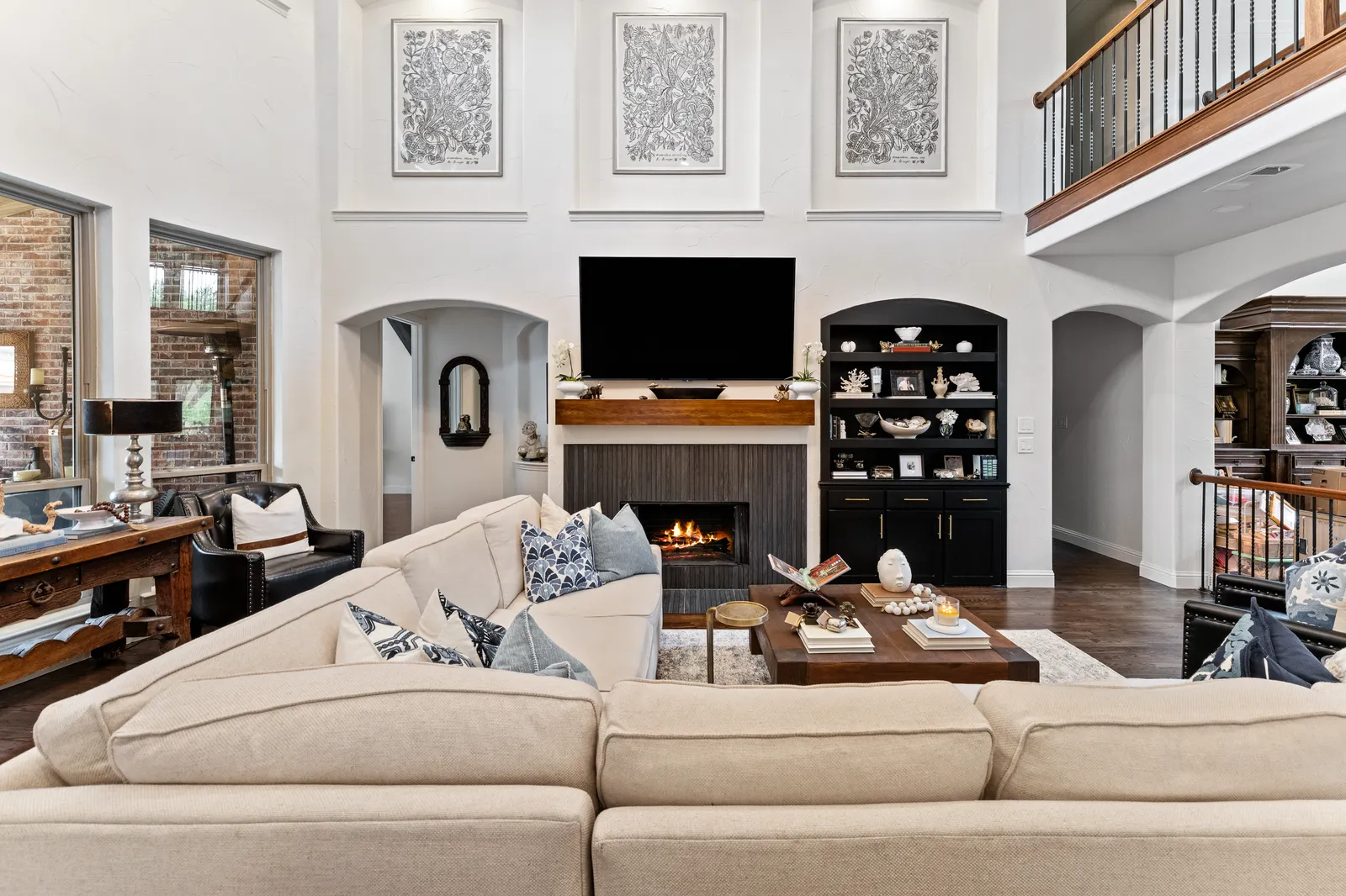 Living room at Shady Point Dr in Plano, TX after a whole-home remodel by Renovation Sells Dallas: new fireplace, built-ins, and updated lighting
